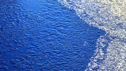 Ice melting from blue color surface, fusion time lapse view