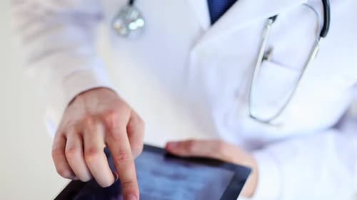 Doctor using tablet with x-ray image