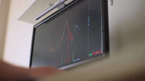 Closeup Lowangle View of Unrecognizable Male Trader Analyzing Realtime Stocks Exchange Market Charts
