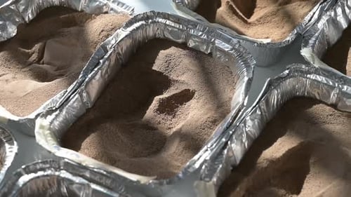 Sand and soil samples in containers in a laboratory for chemical testing