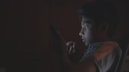 Child Using Phone in the Dark at Home