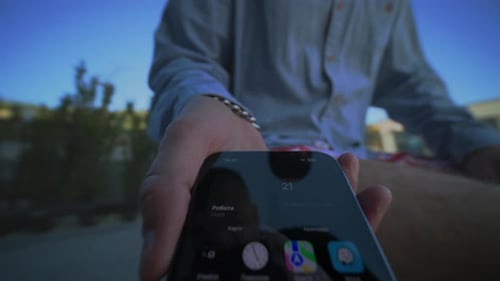 Influencer Captures App Icons Outdoors Reflective Smartphone Display with App Icons Outdoors for
