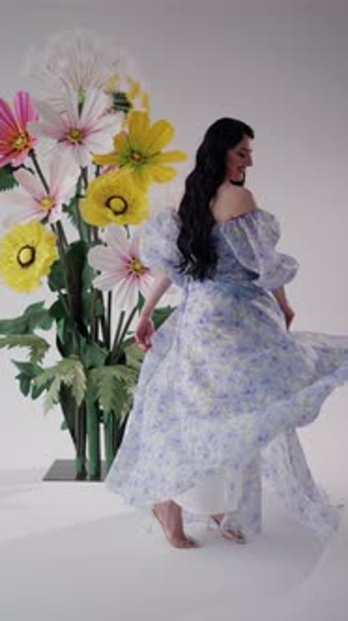 Woman in Floral Dress Twirling in Studio