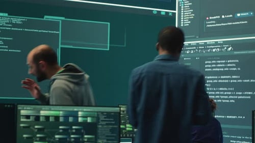 Software Developers Discuss Code in Office Environment