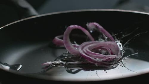 Red Onion Into Pan with Oil in Super, On