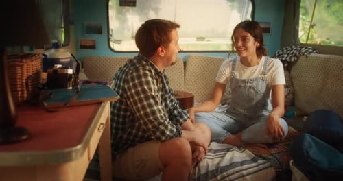 Young Couple Laughing Inside a Camper Van