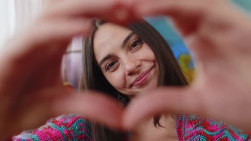 Woman Makes Heart Shape With Hands Smiling Close Up