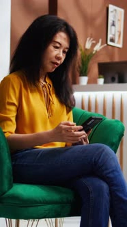 Woman Using Smartphone and Drinking Coffee in Cafe