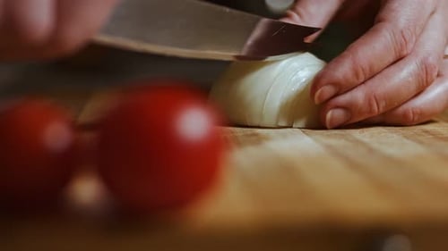 Chopping the Onion on a Wooden Board Close Up