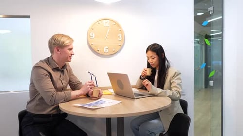 Coworkers Collaborating on a Project in Modern Office