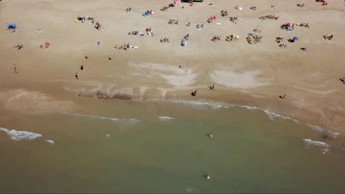 Mediterranean beach during summer with people in the water