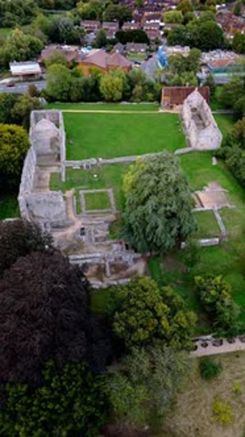 aerial drone shot portrait panning over bishops waltham palace ruins in village in autumn at sunset