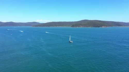 Drone, mountains and landscape with yacht in ocean for sailing, travel and summer vacation