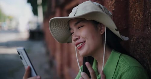 Young Woman Video Calling with Smartphone Outside