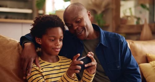 Happiness, father and boy on sofa, smartphone and digital app for online game, playing and relax