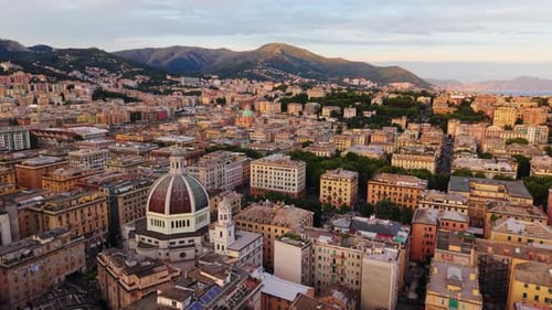 Drone Forward Flight Over Genoa with Colorful Buildings, Churches, Sea and Mountains at Sunset