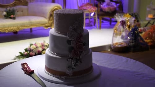 Elegant Three-Tiered Wedding Cake with Floral Decorations