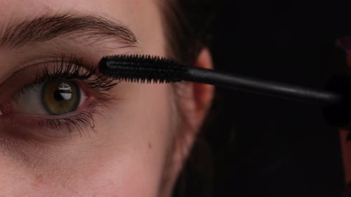 Young Girl Making Makeup Applies Black Mascara On Her Eyelashes Professional Master Class CloseUp