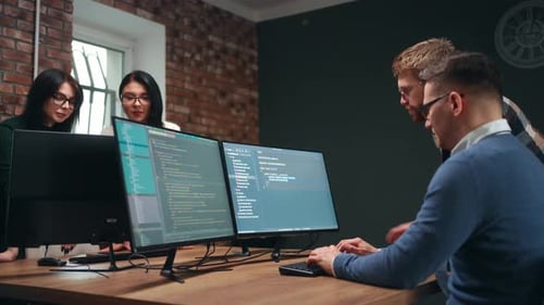 Male and Female Website Developer Working in Office of ITcompany Teamwork and Collaboration