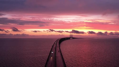 fire sunset over bridge with traffic shot on drone