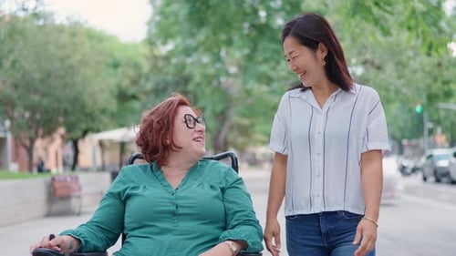 Woman in Wheelchair with Friend Outdoors