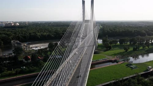 Aerial view of car traffic on modern cable-stayed bridge over river