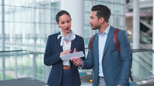 Woman, man and point for direction at airport concierge, help and question with check in lobby