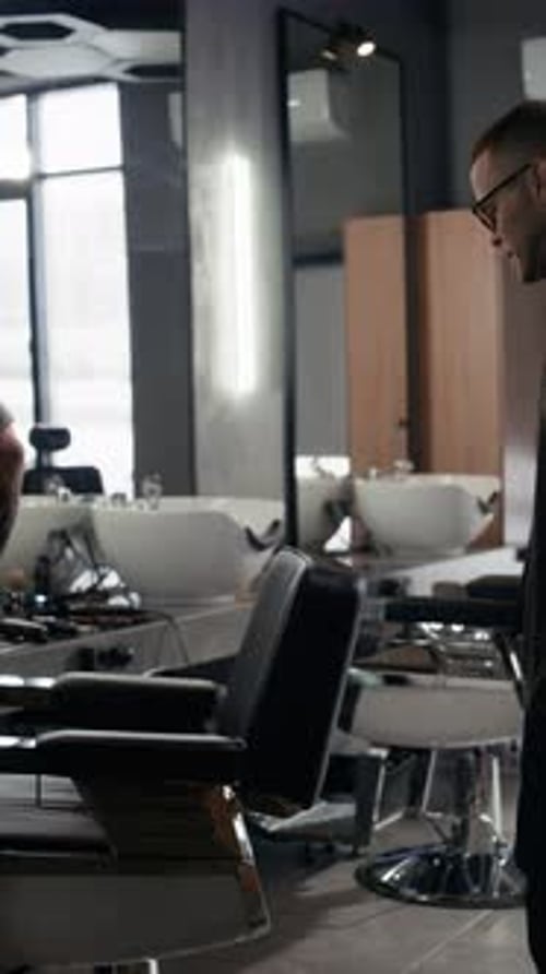 Smiling Barber Greeting His Client
