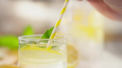 Refreshing Lemon Drink with Yellow Striped Straw