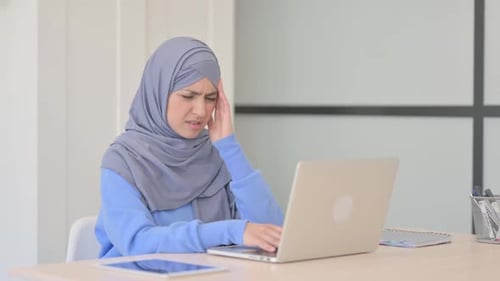 Woman Working on Laptop, Gets a Headache