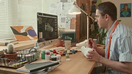 Artist Hand-Painting a Shoe in Studio