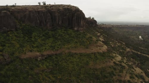Aerial: California butte peak overlooking canyon mountain plateau, cloudy day