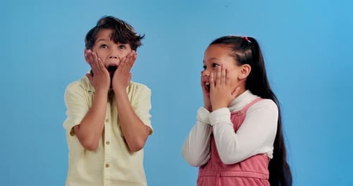 Shock, surprise and face of children on blue background for news, announcement and information