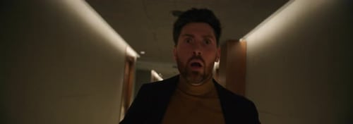 Footage of Scared Young Bearded Man in Formal Clothes Running Down Hallway Indoors Shot of