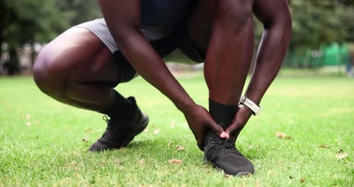 Outdoor, man and ankle pain with closeup, fitness and grass field with exercise
