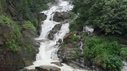 Waterfall Cascading Down Rocks in a Natural Landscape