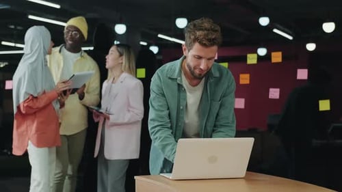European Businessman Works in the Office Using a Laptop
