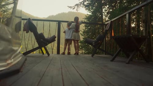 Siblings Look at Forest Hugging Each Other on Terrace