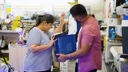 Indian Couple Buying Portable Refrigerator for Car in Appliances Store