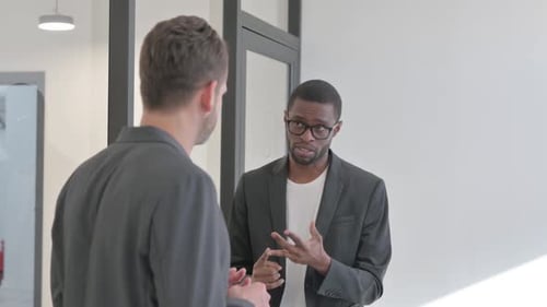 Talking Multi Ethnic Teammates Standing in Office