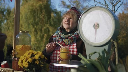 Woman Selling Honey at Outdoor Autumn Market