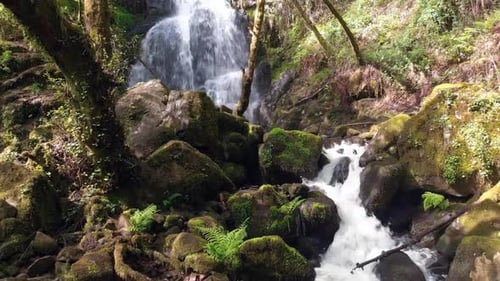 Majestic Hidden Waterfall Cascading Through Rocks In The Forest.