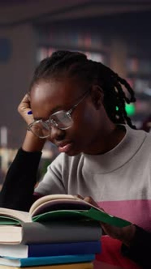 Vertical Video Exhausted Student Falling Asleep While She Reads for Periodical Exams