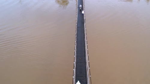 Daily Commute, Students and Villagers Crossing the Suspension Bridge Over Banjarmasin River