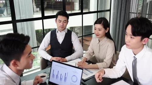 Business Team Collaborating on Laptop Data Analysis