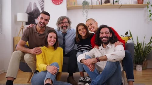 Smiling Group Poses Together on Couch