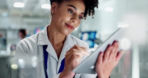 Woman Working on Tablet in Modern Laboratory