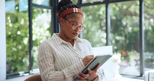 Woman Using Tablet in Office with Natural Light