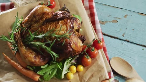 Close up view of cooked chicken and multiple food ingredients on wooden surface