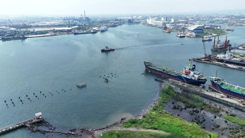 Aerial Overview of Busy Cargo Ship Port, Industrial Area, and Skyline